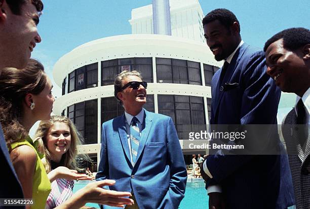David Eisenhower grandson of former President Eisenhower, and his fiance Julie Nixon daughter of Richard Nixon, are shown with basketball star Wilt...