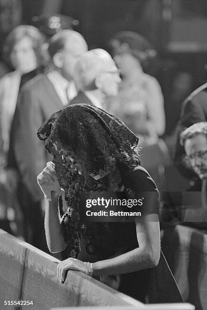 Mrs. John F. Kennedy, who lost her husband to an assassin;s bullet in November prays for her slain brother-in-law, Senator Robert F. Kennedy, in St....