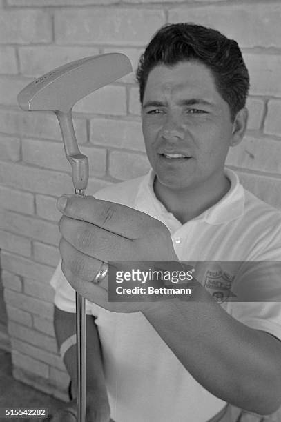 Open champion Lee Trevino admires a brand new putter which he used for the first time to fashion a one under par 69 good for the early first round...