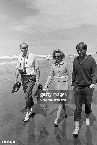 Pants cuffs rolled up, New York Senator Robert F. Kennedy takes a brief "time out" from the campaign trail as he joins his wife, Ethel, and Oregon...