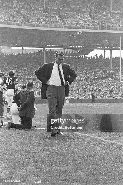 Jim Dooley, head coach of the Chicago Bears, is shown on the sidelines during the game. He is also shown with Gale Sayers on the sidelines.