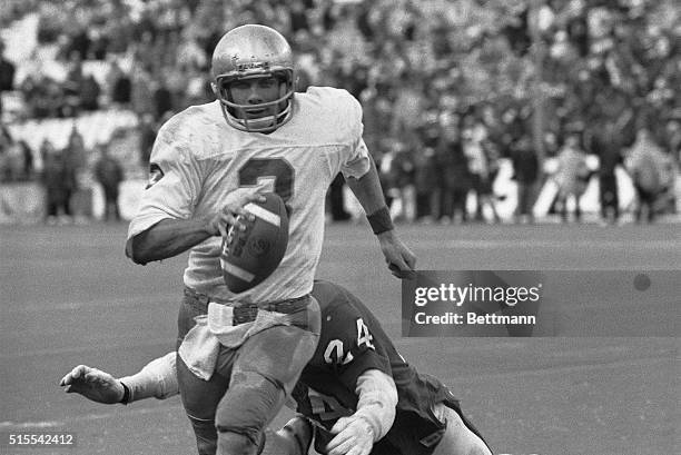 Notre Dame quarterback Joe Montana runs out of the arms of Houston's Fred Snell during the final drive of the game that led to Notre Dame's 35-34...