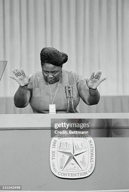 Fannie Lou Hamer of Mississippi gestures with her hands as she speaks from the rostrum here, addressing the delegates on the fight over Alabama...