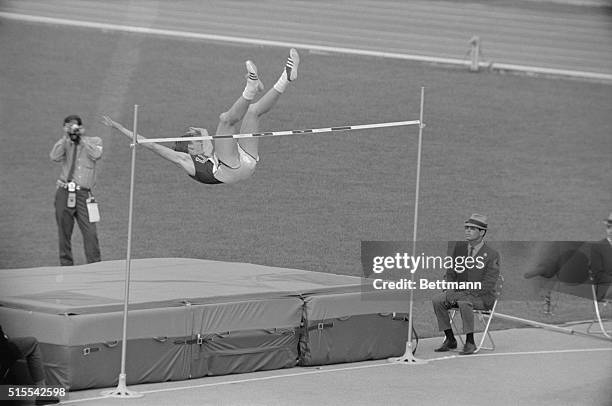 Dick Fosbury, of Medford, Oregon, the high jumper who goes over the bar backwards, is shown in his unorthodox manner during the Olympic high jump...