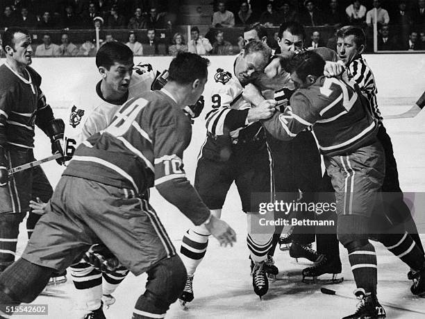 In one of the many major fights which riddled the game, Bobby Hull of Chicago, on the left, slugs it out with John Ferguson of the Canadiens. Hull...