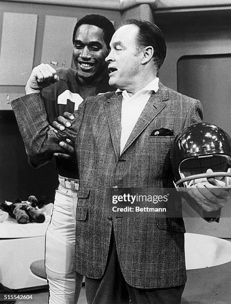 Comedian Bob Hope clowns with the University of Southern California's All-America halfback O.J. Simpson. Hope was at the Los Angeles Sports Arena to...