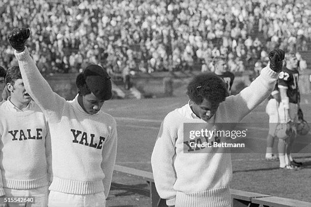 New Haven, Conn.: Yale cheer leaders Greg Parker and Bill Brown give the Black Power salute during the National Anthem starting the Yale-Dartmouth...