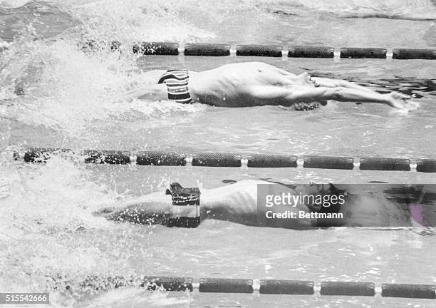 Mexico City: East Germany's Roland Matthes and Charles Hickcox of the USA catapult from the start of the men's 100 meters backstroke final of the...