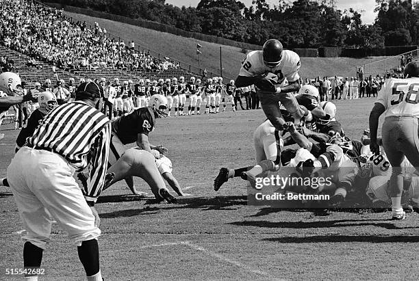 University of Southern California's O.J. Simpson takes to the air as he soars over the Stanford line to score early in the second quarter. Paced by...