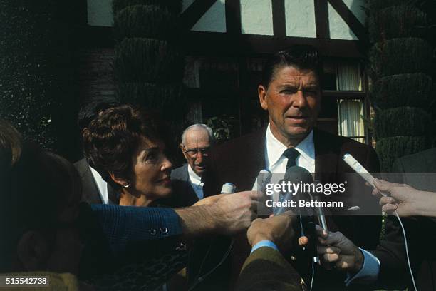 Governor Ronald Reagan, and his wife Nancy Reagan are shown speaking to newsmen as they leave polling place.