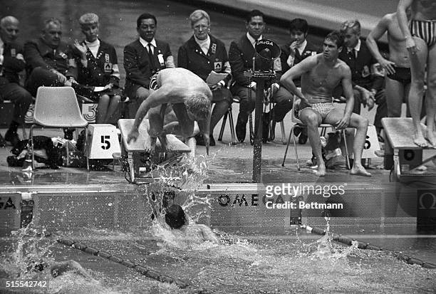 S Mark Spitz no sooner touches the wall than teammate Don Schollander dives out over him to cinch a US gold medal in the men's 800-meter freestyle...