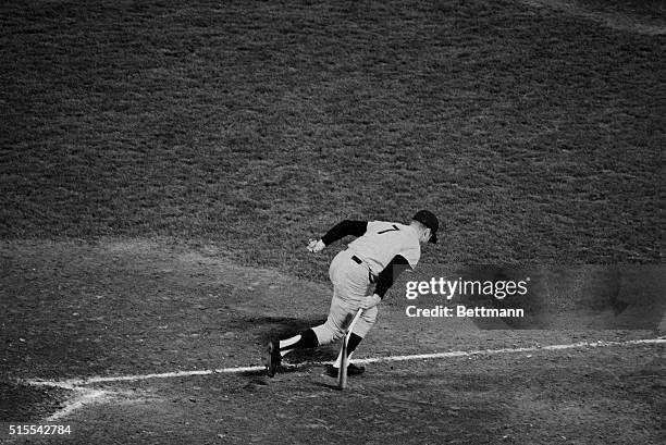 New York's Mickey Mantle cracks his bat as he slams it to the ground and heads for first base after hitting a long fly to center field in seventh...