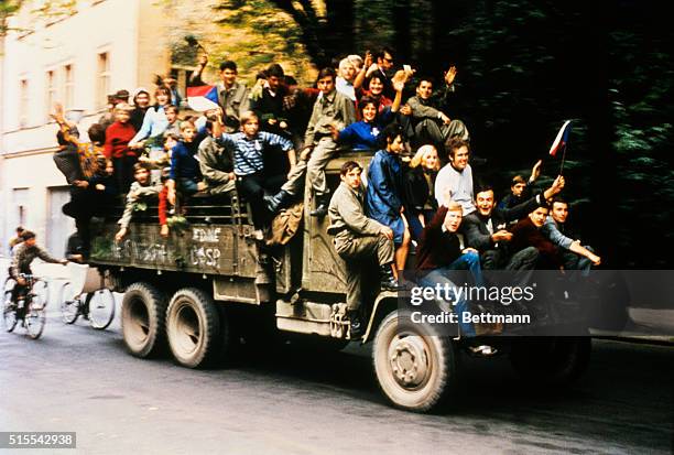 These shots show Czechoslovakia army trucks taking youngsters around the city as Soviet tanks halted on the outskirts and began siege of Czech army...