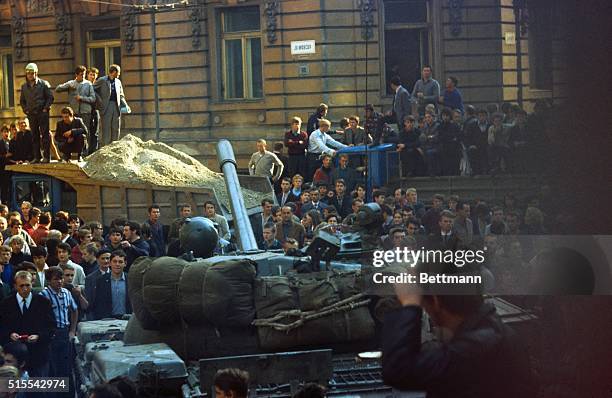 Youngsters clambering on a Soviet tank here yesterday as Soviet troops took over Czechoslovakia. The crowds surrounding the Russian armoured vehicles...