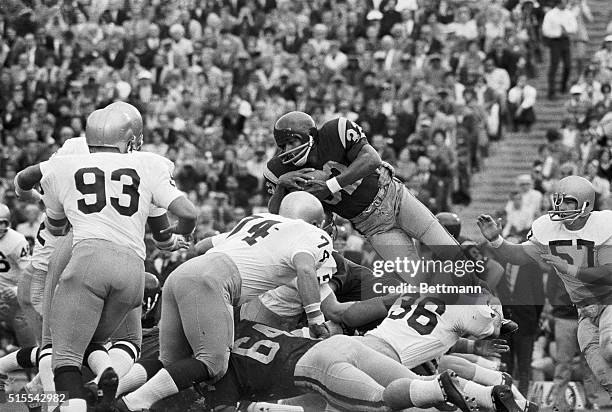 Trojan halfback O.J. Simpson tries to vault over the line but can only manage a few yards as he is caught in midair by Irish linebacker Bob Olson in...