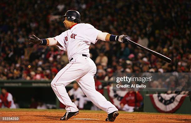 Manny Ramirez of the Boston Red Sox hits a RBI single in the seventh inning against the St. Louis Cardinals during game one of the World Series on...