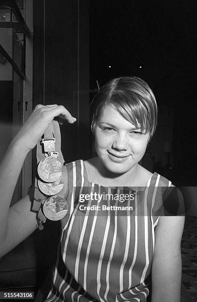 Sixteen-year-old Debbie Meyer of Sacramento, California, the only swimmer ever to win three individual gold medals in the Olympic games, poses...