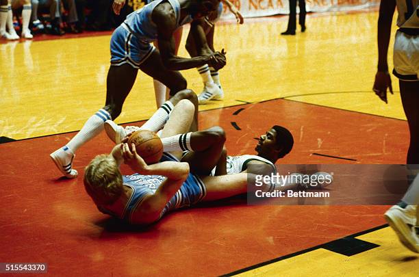 Indiana State's Larry Bird and Michigan State's Earvin Johnson are a tangle on the floor under the Michigan State basket early in the NCAA national...