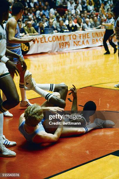 Indiana State's Larry Bird and Michigan State's Earvin Johnson are a tangle on the floor under the Michigan State basket early in the NCAA national...