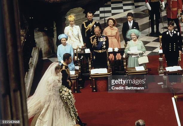 Prince Charles and Lady Diana Spencer stand at the altar as the Queen Mum and other members of the Royal Family attend the wedding.