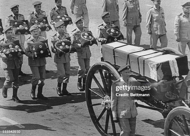 The gun carriage of slain President Anwar Sadat is escorted by armed forces bearing medals in the funeral procession here, in the suburb of Nasser...