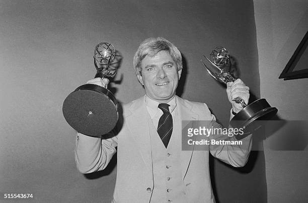 New York: With Marlo Thomas at his side, Phil Donahue holds Emmy he received as "Outstanding Host" 5/17, here when the National Academy of Television...