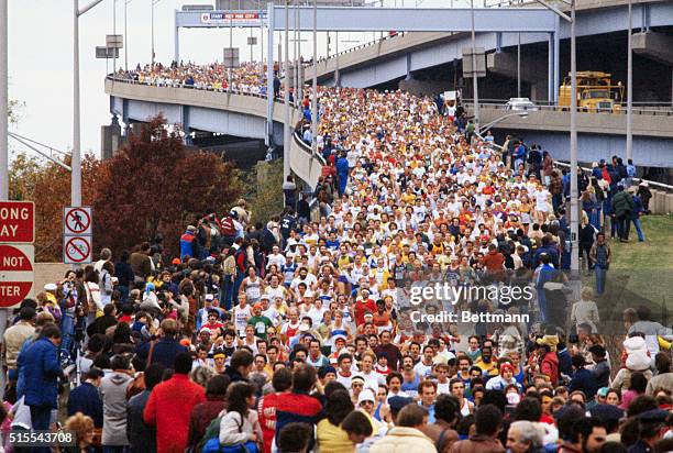 Some of the 16,000-plus entrants in the New York City Marathon come off the Verrazano-Narrows Bridge just after the start 10/25. The race was won by...
