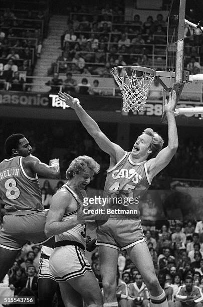 Celtics' Larry Bird finds the going rough as he attempts to make a basket in the 1st quarter at Boston Garden, 1/6. Cavaliers Lonnie Shelton and Jeff...