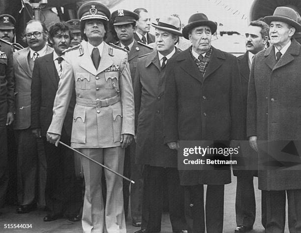 Holding a swagger stick, Libyan leader Colonel Muammar al-Qaddafi stands with Soviet Pres. Leonid Brezhnev at welcoming ceremonies at Moscow's...