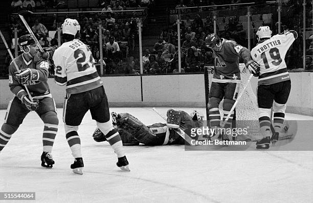 Uniondale, New York: Goalie Clint Malarchuk of Quebec peers into his nets as teammate Mario Marois stares down at him after Mike Bossy of the...