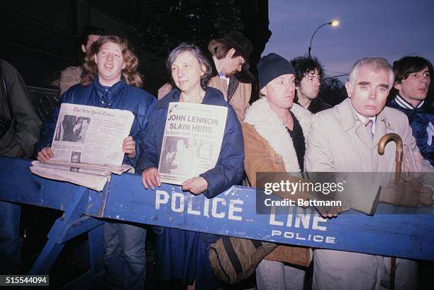 New York: Distraught fans of ex-Beatle John Lennon gather outside his apartment building , late December 8, after he was gunned down by a man...