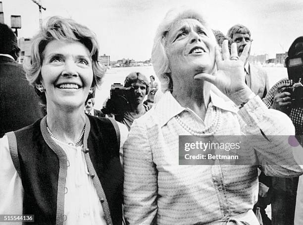 Baltimore: Nancy Reagan, , watches as Barbara Bush, , yells to a crowd to support their husbands in the upcoming presidential election. Both women...