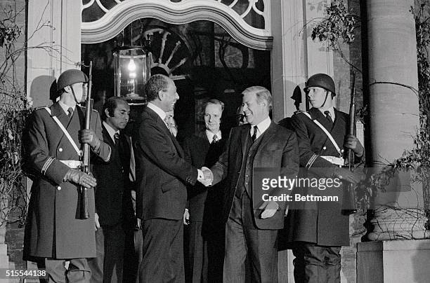 West German Chancellor Helmut Schmidt and Egyptian President Anwar Sadat shake hands after their meeting at the Gymnich castle in Bonn.