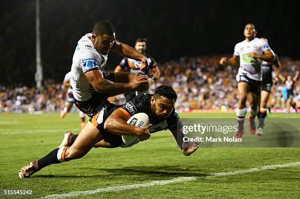 Dylan Walker of the Eagles attempts to prevent David Nofoaluma of the Tigers from scoring a try during the round two NRL match between the Wests...