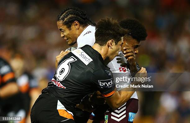 Steve Matai of the Eagles is tackled during the round two NRL match between the Wests Tigers and the Manly Sea Eagles at Leichhardt Oval on March 14,...