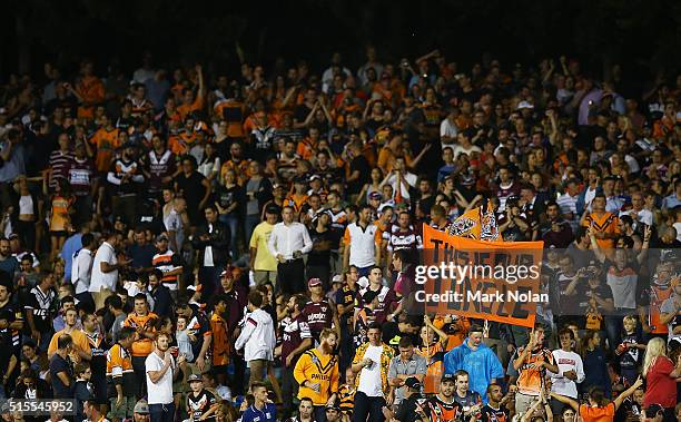 Fans watch on during the round two NRL match between the Wests Tigers and the Manly Sea Eagles at Leichhardt Oval on March 14, 2016 in Sydney,...