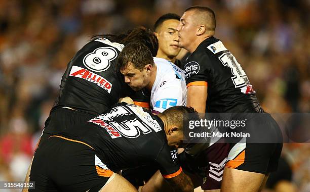 Brenton Lawrence of the Eagles is tackled during the round two NRL match between the Wests Tigers and the Manly Sea Eagles at Leichhardt Oval on...