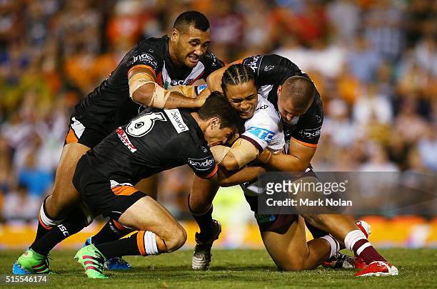 Steve Matai of the Eagles is tackled during the round two NRL match between the Wests Tigers and the Manly Sea Eagles at Leichhardt Oval on March 14,...
