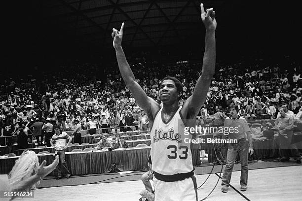 Michigan State guard Earvin Johnson raises his hands and holds up one finger to denote that Michigan State is number ONE after they beat the Indiana...
