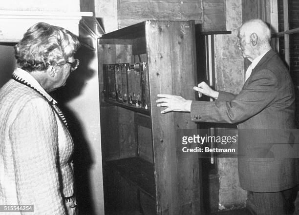 Amsterdam, The Netherlands: Mr. Otto Frank, father of Anne Frank, shows Queen Juliana of The Netherlands the hiding place of the Frank family during...