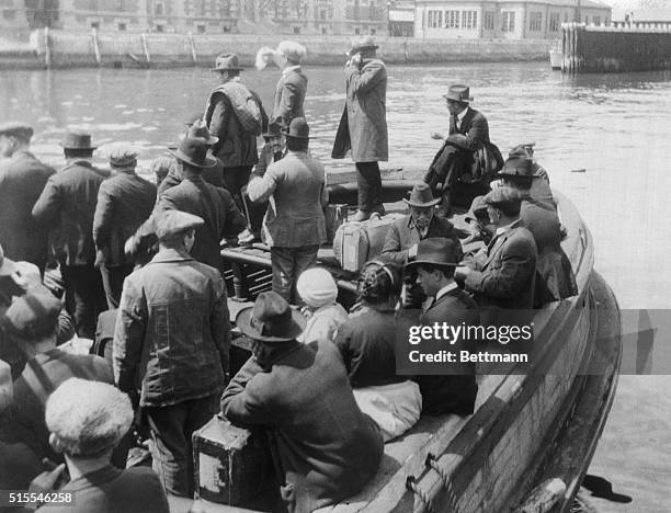 Quota law sends them back to native lands....New York...waving a sad fare well to friends on the dock at Ellis island, these would-be immigrants,...