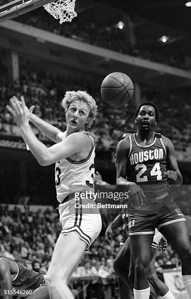 Celtics' Larry Bird and Rockets Moses Malone watch the ball intended for Bird fly by during 2nd quarter action in game 1 of the NBA Championship...