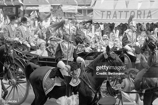 Queen Elizabeth and her husband Prince Philip riding in the semi-state coach to St. Pauls Cathedral for the wedding of their son Prince Charles to...