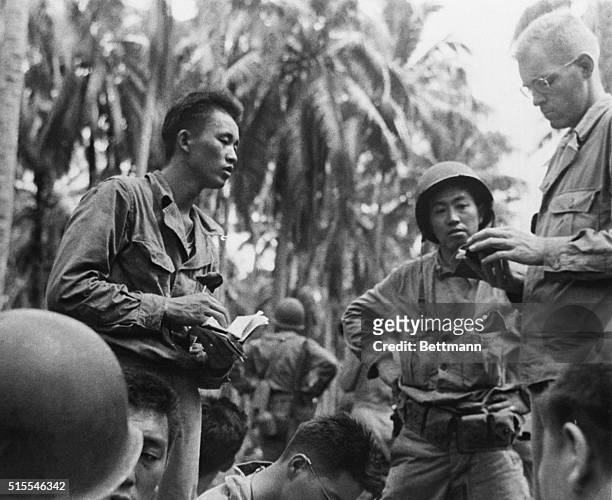 Interpreters of the U.S. Army decipher papers found on a wounded Japanese officer. | Location: Rendova Island, Solomon Islands.