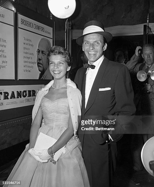 Hollywood: Singer Frank Sinatra and his teenage daughter Nancy arrive at the movie premiere of Sinatra's latest picture, "Not As A Stranger."