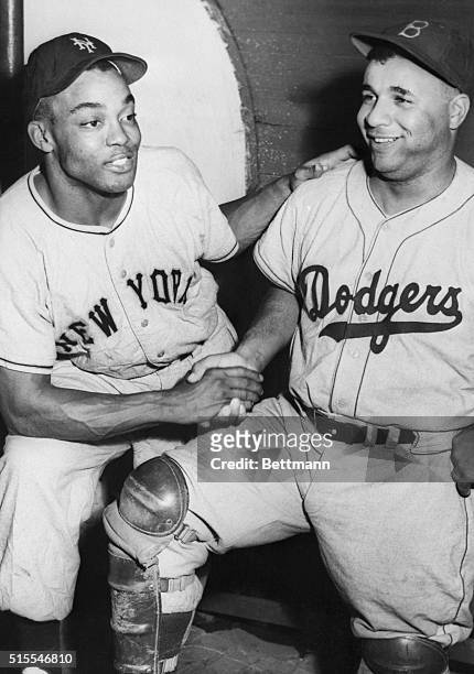 New York Giants outfielder Monte Irvin congratulates Roy Campanella of the Dodgers on winning the National League Most Valuable Player award for...