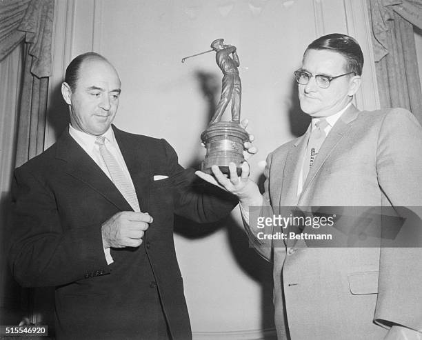 Sam Snead admires the trophy presented to Dale Bourisseau, WWI amputee, and recipient of the Ben Hogan award which was presented to the golfer making...