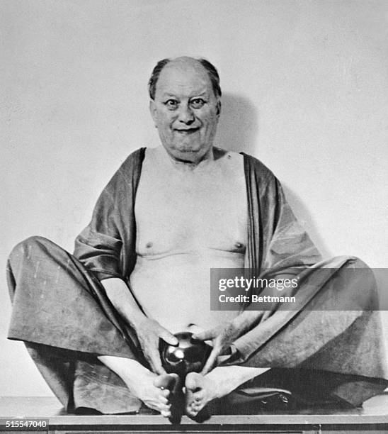 Aleister Crowley is shown as Fo Hi, the Chinese God of laughter and money.