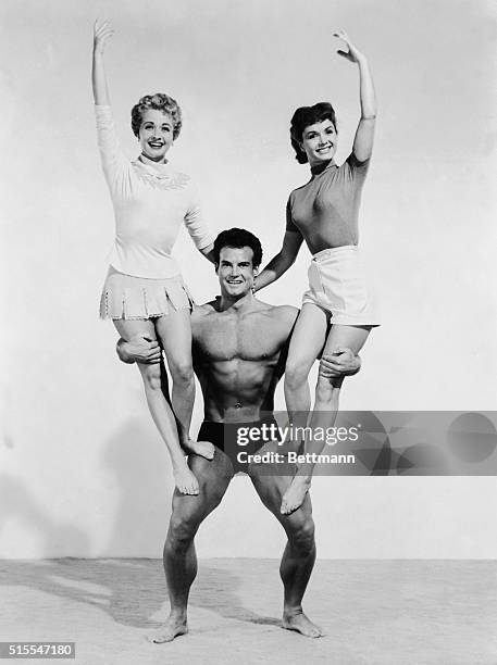 The young man of might with his arms full of Jane Powell and Debbie Reynolds is Steve Reeves, better known as "Mr. America of 1947"; "Mr. World of...