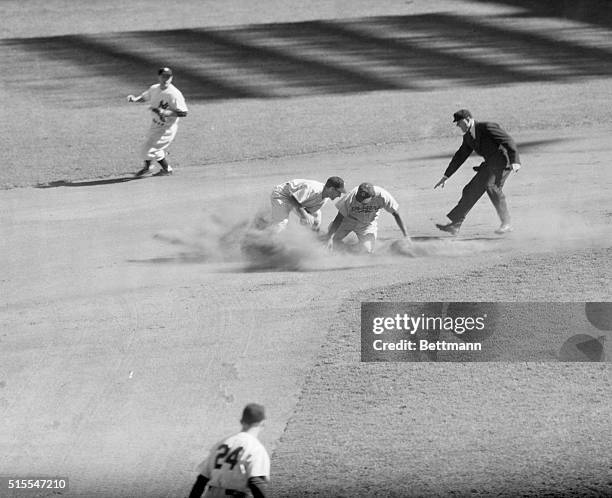 Jackie Robinson of the Brooklyn Dodgers, breaking the color barrier this season as the first African American to play in the Major Leagues, safely...